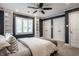 Spacious bedroom with a ceiling fan, built-in shelving, and bright natural light from shuttered windows at 7575 Central Ave, Indianapolis, IN 46240