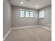 Neutral bedroom with carpeted floors, bright natural light, and a window view of the outdoors at 7575 Central Ave, Indianapolis, IN 46240