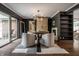 Stylish dining room with unique light fixture, fireplace, and sliding doors for seamless indoor-outdoor living at 7575 Central Ave, Indianapolis, IN 46240
