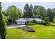 Charming single-story home with an attached two car garage, landscaped yard, and mature trees at 7575 Central Ave, Indianapolis, IN 46240