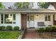 Charming single-story home showcasing a welcoming front entrance with brick accents, neat landscaping, and ample light at 7575 Central Ave, Indianapolis, IN 46240