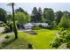 Expansive front yard featuring a well-manicured lawn and a charming home with a two-car garage at 7575 Central Ave, Indianapolis, IN 46240
