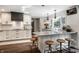 Modern kitchen with white cabinetry, herringbone backsplash, quartz countertop island and stainless appliances at 7575 Central Ave, Indianapolis, IN 46240