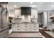 Kitchen with white cabinets, black range hood, and stainless steel appliances at 7575 Central Ave, Indianapolis, IN 46240