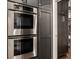 Kitchen with double oven and dark wood cabinets and pantry at 7575 Central Ave, Indianapolis, IN 46240