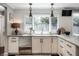 Bright kitchen featuring stainless steel appliances, white cabinets, and large windows at 7575 Central Ave, Indianapolis, IN 46240