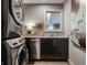 Well-lit laundry room boasts modern washer and dryer, sleek cabinetry, and elegant countertop space at 7575 Central Ave, Indianapolis, IN 46240