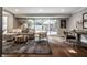Well-lit living room featuring a comfortable sofa, workspace, and large windows offering scenic outdoor views at 7575 Central Ave, Indianapolis, IN 46240