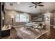 Cozy living room with hardwood floors, decorative rug, and comfortable seating under a ceiling fan at 7575 Central Ave, Indianapolis, IN 46240