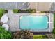 Aerial view of a backyard pool with an umbrella covered seating area on a paver patio at 7575 Central Ave, Indianapolis, IN 46240