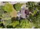 Aerial view of a private home with lush greenery and a charming yard at 7734 Hoover Rd, Indianapolis, IN 46260