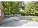 Backyard deck with built in seating and wood railing overlooking the yard and surrounding trees at 7734 Hoover Rd, Indianapolis, IN 46260