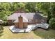 Expansive backyard featuring a large wooden deck and brick chimney at 7734 Hoover Rd, Indianapolis, IN 46260