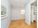 Cozy bedroom featuring hardwood floors and an open closet with built in shelving at 7734 Hoover Rd, Indianapolis, IN 46260