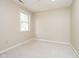 Bright bedroom with neutral carpet and natural light from a large window at 7734 Hoover Rd, Indianapolis, IN 46260