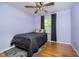 Comfortable bedroom with wooden floors and ceiling fan for year round comfort at 7734 Hoover Rd, Indianapolis, IN 46260