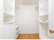 Spacious walk-in closet with built in shelving and hardwood floors at 7734 Hoover Rd, Indianapolis, IN 46260