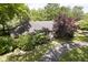 Charming single-story brick home featuring mature trees and a private driveway at 7734 Hoover Rd, Indianapolis, IN 46260