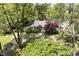 Aerial view of a home showcasing its lush landscaping and circular driveway at 7734 Hoover Rd, Indianapolis, IN 46260