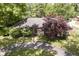 Aerial shot of a charming home with a well-manicured front yard and mature trees at 7734 Hoover Rd, Indianapolis, IN 46260