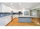 Bright and spacious kitchen with a center island, stainless steel appliances, and white cabinetry at 7734 Hoover Rd, Indianapolis, IN 46260