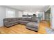 Open floor plan flows into a modern kitchen with white cabinets and blue island at 7734 Hoover Rd, Indianapolis, IN 46260