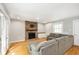 Inviting living room features a cozy brick fireplace and comfortable gray sectional sofa at 7734 Hoover Rd, Indianapolis, IN 46260