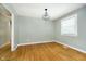 Inviting living space with hardwood floors, modern light fixture, and a bright window offering natural light at 7734 Hoover Rd, Indianapolis, IN 46260
