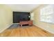 Home office features hardwood flooring, a chalkboard wall, and a modern desk setup by a window at 7734 Hoover Rd, Indianapolis, IN 46260