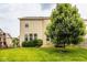 A lovely backyard featuring a deck, mature trees, lush greenery and a swing set at 7824 Hedgehop Dr, Zionsville, IN 46077