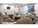 Basement living area features a comfy sofa, unique flooring, and barn doors leading to another room at 7824 Hedgehop Dr, Zionsville, IN 46077