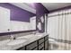 Bathroom features a double vanity with granite countertops, modern fixtures, and a shower-tub combination at 7824 Hedgehop Dr, Zionsville, IN 46077