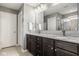 Bathroom features double vanity with dark cabinets, granite countertop, and walk-in shower at 7824 Hedgehop Dr, Zionsville, IN 46077