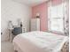 Bedroom featuring soft pink accents, a cozy bed, stylish decor, and a window providing natural light at 7824 Hedgehop Dr, Zionsville, IN 46077