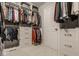 Walk-in closet features an organized storage system with shelving, drawers, and clothing racks for optimal organization at 7824 Hedgehop Dr, Zionsville, IN 46077