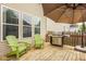 The deck features a grill, patio umbrella and green Adirondack chairs for relaxing at 7824 Hedgehop Dr, Zionsville, IN 46077