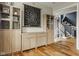 Entryway with wooden cabinets and hardwood floors leading to a staircase with patterned wall at 7824 Hedgehop Dr, Zionsville, IN 46077