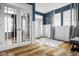 Welcoming entryway with hardwood floors, a patterned rug, french doors, and stylish blue walls at 7824 Hedgehop Dr, Zionsville, IN 46077