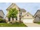 Attractive two-story home with a two-car garage, beautiful landscaping, and a welcoming front entrance at 7824 Hedgehop Dr, Zionsville, IN 46077