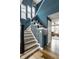 Stylish foyer with hardwood floors, blue walls, a staircase, and access to other rooms at 7824 Hedgehop Dr, Zionsville, IN 46077