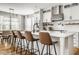 Bright, modern kitchen features an island with barstool seating and modern appliances at 7824 Hedgehop Dr, Zionsville, IN 46077