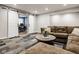 Stylish living room shows a large sectional sofa, decorative carpet, and sliding barn doors to the office at 7824 Hedgehop Dr, Zionsville, IN 46077