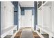 Mudroom with wood floor, cubbies, bench and coat hooks for storage at 7824 Hedgehop Dr, Zionsville, IN 46077