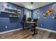Bright office features floating shelves, hardwood floors, and a custom wood-carved world map at 7824 Hedgehop Dr, Zionsville, IN 46077