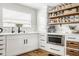 Convenient pantry with ample storage and an under-counter microwave oven at 7824 Hedgehop Dr, Zionsville, IN 46077