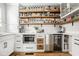 Organized pantry features wood shelving and a beverage fridge for added convenience at 7824 Hedgehop Dr, Zionsville, IN 46077