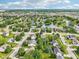 Beautiful aerial view of homes in a suburban neighborhood surrounding a serene lake with lush green trees at 7970 Cobblesprings Dr, Avon, IN 46123