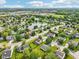 An aerial shot shows a neighborhood with mature trees and landscaping and a winding lake at 7970 Cobblesprings Dr, Avon, IN 46123