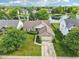 Aerial view showcases the property with a driveway and landscaping, complemented by a serene lake backdrop at 7970 Cobblesprings Dr, Avon, IN 46123
