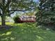 Back yard with a well-maintained lawn and a wooden deck at 7970 Cobblesprings Dr, Avon, IN 46123